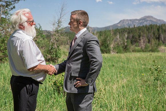 Groom and father shaking hands